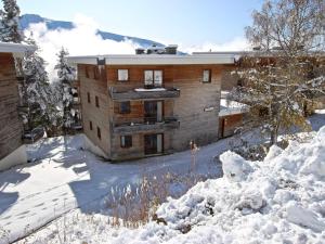 a building in the snow with a lot of snow at Appartement 3* avec terrasse plein sud, proche pistes et commerces à Chamrousse - FR-1-549-92 in Chamrousse