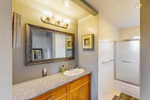 a bathroom with a sink and a mirror and a shower at Blue Waves Overlook in Newport +23 photos