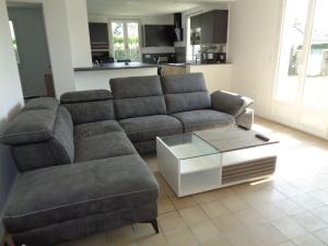 a living room with a couch and a coffee table at Maison avec terrain clos in Denneville-Plage