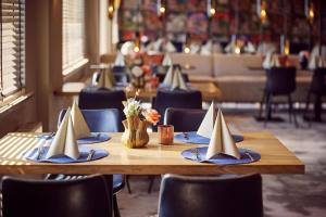 un tavolo in legno con tovaglioli e battelli di carta di Ferienhaus im Van der Valk Resort in Linstow a Dobbin-Linstow
