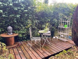 two chairs and a table on a wooden deck at Chambre aménagée à Quintal in Quintal +5 photos