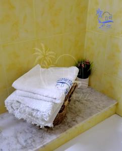 a pile of towels sitting on a counter in a bathroom at Beit El Ezz - la maison in Ouled Yaneg +21 photos