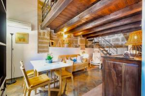 a living room with a table and a couch at Emerald apartment in Alghero Historic Center in Alghero