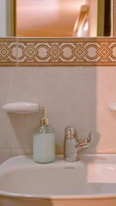 a soap dispenser sitting on top of a bathroom sink at Casa Mompa in Bucaramanga +41 photos