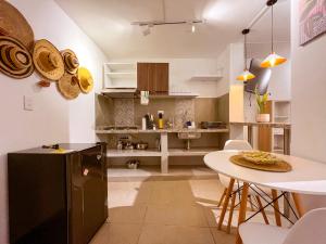 a kitchen with a table and a dining room at Casa Mompa in Bucaramanga