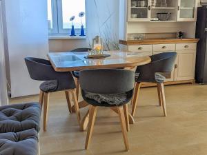 a dining table and chairs in a kitchen at Comfortable holiday home in nature in Schönberg