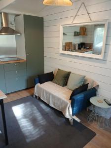 a living room with a couch and a table at Chez Eve 2 in Nîmes