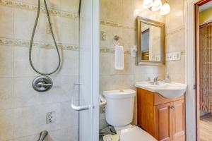a bathroom with a toilet and a sink and a shower at 2 Mi to Walden Galleria Home with Furnished Deck! in Cheektowaga +18 photos