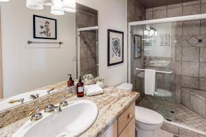 a bathroom with a sink and a toilet and a shower at Dogleg Retreat in Sunriver +28 photos