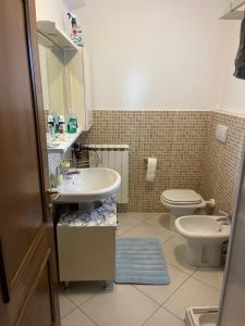 a bathroom with a sink and a toilet at Affitta Camere DA MARIA 1 in Albiano +2 photos