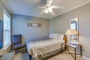 a bedroom with a bed and a chair and a ceiling fan at Southern Comfort Oasis in Valdosta