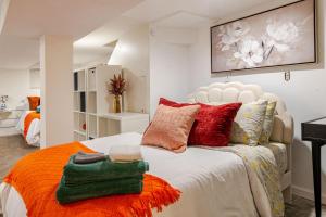 a bedroom with a large bed with colorful pillows at Elegant 4BR & 4BA House in DC in Washington