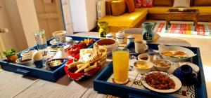 a table with a tray of food and drinks on it at Beit El Ezz - la maison in Ouled Yaneg