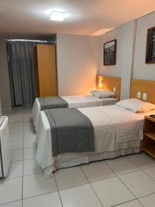 Postel nebo postele na pokoji v ubytování Absolutte Hotel
