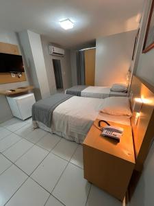 Postel nebo postele na pokoji v ubytování Absolutte Hotel