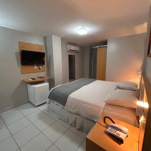 Postel nebo postele na pokoji v ubytování Absolutte Hotel