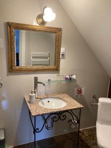 a bathroom with a sink and a mirror at Ciao Italia in Gdynia
