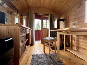 a wooden room with a table and a stool at Kuscheltage im Zirkuswagen am Kanal im Münsterland in Recke