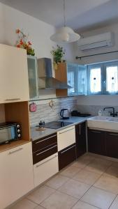 a kitchen with white cabinets and a sink at Casa Bianca in Marina di Massa