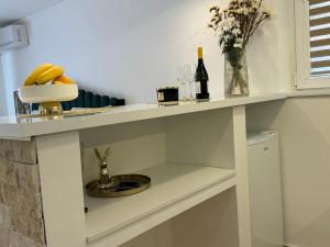 a kitchen with a counter with a sink and wine bottles at Apartman City Zeleznik in Belgrade