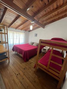 a bedroom with two bunk beds and a wooden ceiling at Dptos7 Playas del sur in Mar del Plata