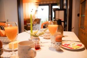 a table with glasses of orange juice and eggs on it at Henneglück2 mit Kamin und Sauna! in Meschede