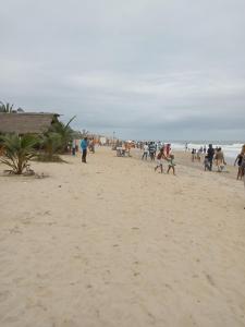 a group of people walking on a beach at Iroko Plage San Pédro in San-Pédro +14 photos
