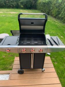 a barbecue grill sitting on a wooden deck at Belle maison 6 personnes à 2min du Lac du Jaunay, et 15min des plages Vendéennes in La Chapelle-Hermier +8 photos