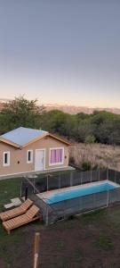 a house with a swimming pool in front of it at El Rincon de las Marias in San Lorenzo