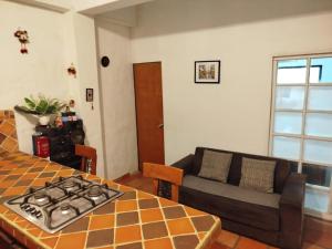 a living room with a couch and a table at Apartamento ALTAMIRA de la VILLA de Leyva in Villa de Leyva