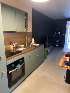 a kitchen with a sink and a stove top oven at Spa, sauna détente #caurel in Caurel