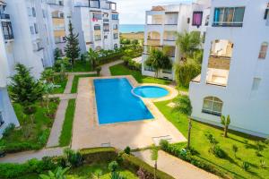 an aerial view of an apartment complex with a swimming pool at la perle du nord by marina golf asilah in Asilah