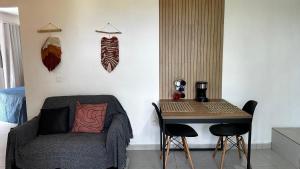 a living room with a couch and a table with chairs at Casa da Floresta in Rio de Janeiro +48 photos