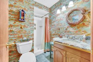 a bathroom with a toilet and a sink and a mirror at 613 Main Street in Park City +17 photos