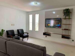 Et tv og/eller underholdning på Casa de Praia 3 Suítes c Ar condicionado e Piscina à 350m da Praia do Morro