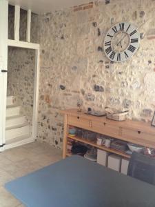 a stone wall with a clock on a wall at Charmante Maison De Pêcheur in Honfleur