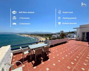 a balcony with a table and chairs and the beach at La Maison Yacht in Cabo Negro