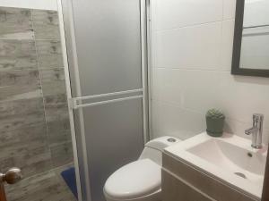 a bathroom with a toilet and a sink at Apartaestudio Los Profes in Mocoa