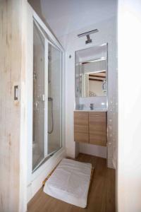a bathroom with a shower and a sink and a mirror at Refúgio Alentejano in Alandroal