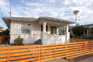 a house with a wooden fence in front of it at Walk To Beach Restaurants - 5 Guests in Long Beach