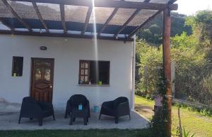 a group of chairs sitting outside of a house at LA MAISON in Lozano