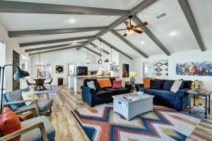 a living room with blue couches and a table at Peach Street Retreat - Fire Pit and Close to Main St in Fredericksburg +26 photos