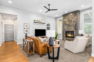 a living room with a couch and chairs and a fireplace at Boise Hills Oasis in Boise