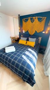 a bedroom with a blue and white bed with yellow pillows at Nautical living in Manly in Sydney +13 photos