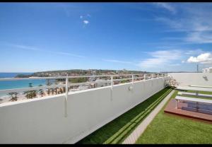 a white balcony with a view of the ocean at Nautical living in Manly in Sydney
