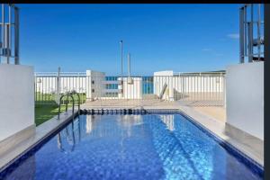 a large swimming pool in front of a building at Nautical living in Manly in Sydney