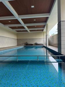 a large swimming pool with a blue pool at Aami dhivahi guest house 03 in Trivandrum