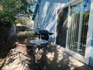 a patio with a table and chairs and a grill at Sugar Shack in Downtown Meridian in Meridian