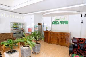a lobby of a green firm with potted plants at MONTE Prundi Hotel in Labuan Bajo