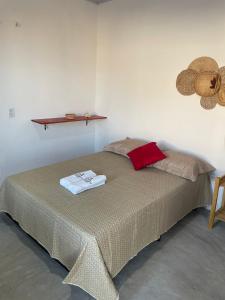 a bedroom with a bed and a shelf on the wall at Villa Careca in Luis Correia